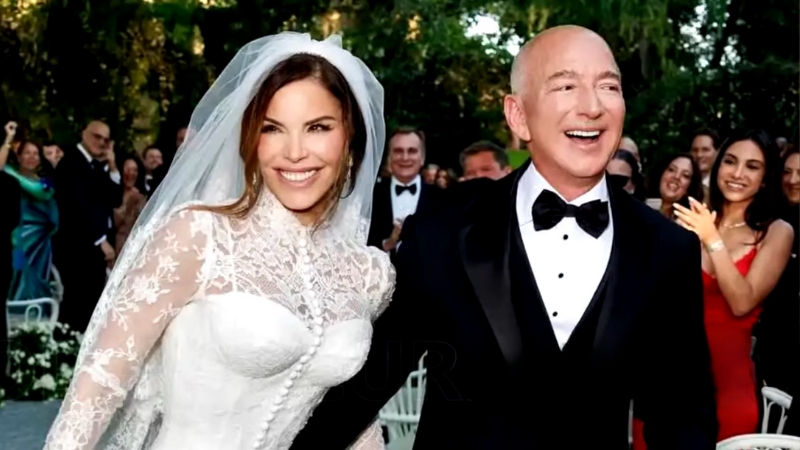 Lauren Sánchez and Jeff Bezos smile after the ceremony, with Lauren Sánchez’s wedding dress featuring a lace bodice and elegant veil